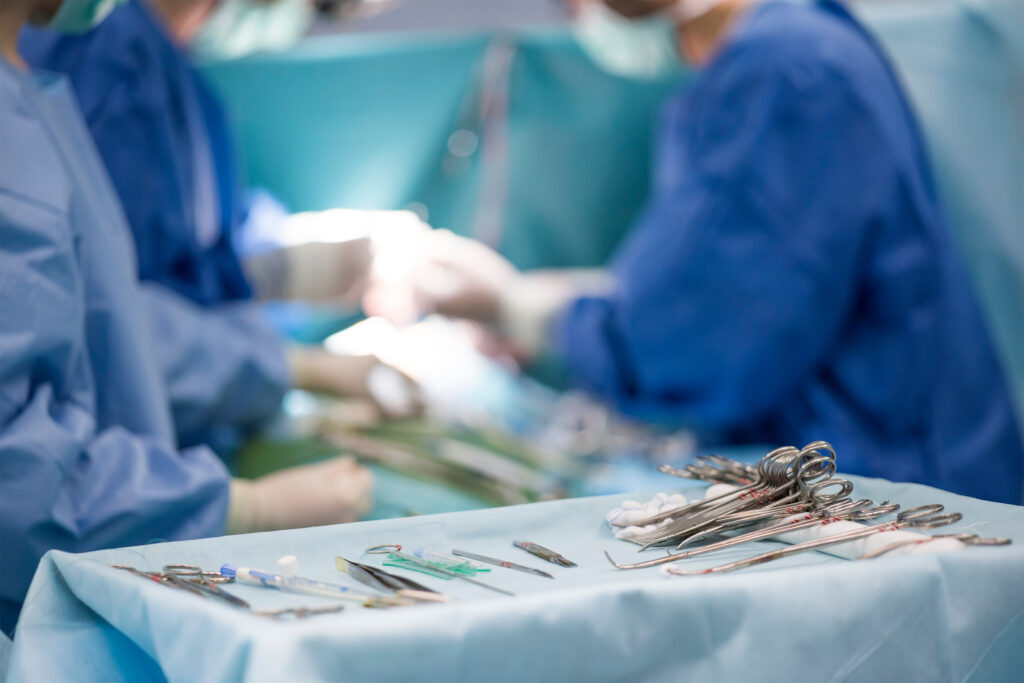 sterile surgical instruments on during the operation table amid the surgeons